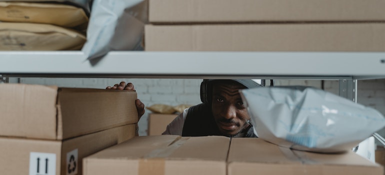a man organizing inventory in storage