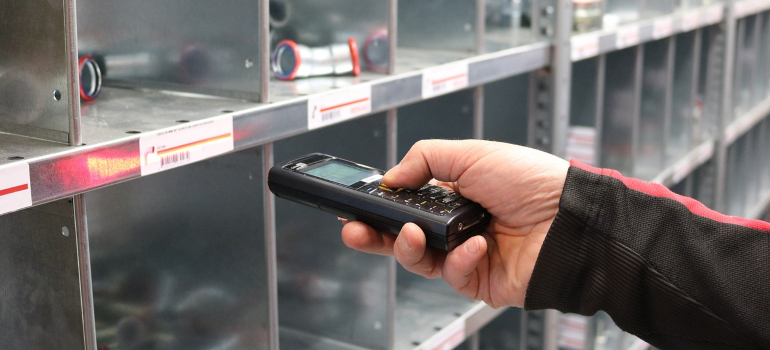 a person easily scanning products in inventory is how renting storage benefits local businesses