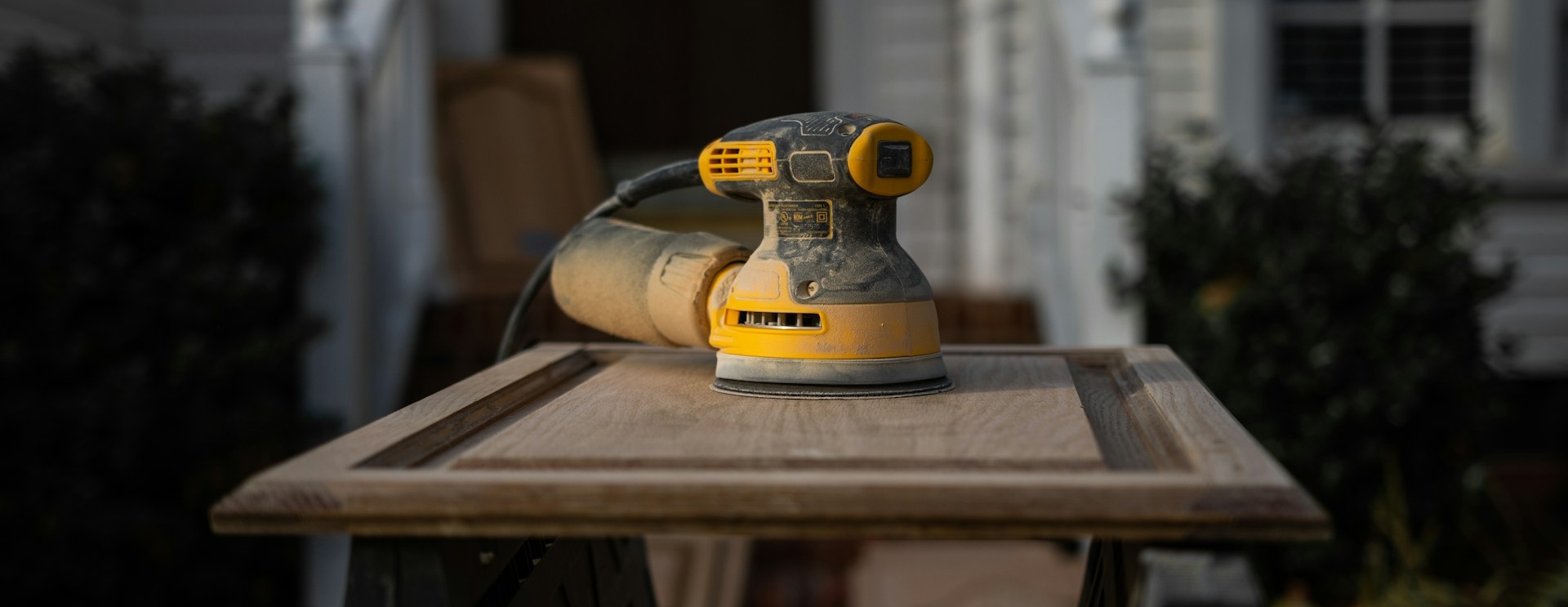 A yellow and black buffer polisher on a workdesk
