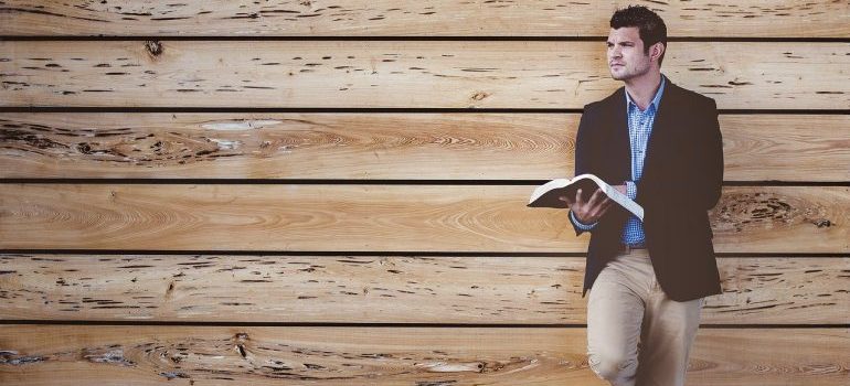 A man reading a book on self-storage safety tips.