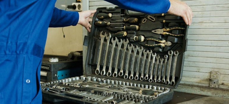 A person storing work tools long-term in a toolbox
