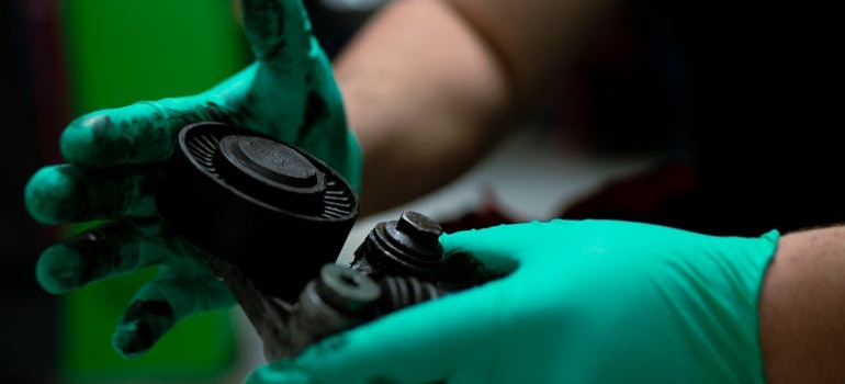 Close up of hands cleaning before storing car parts