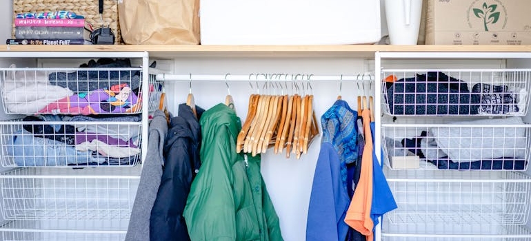 Clothes on hangers in an open wardrobe