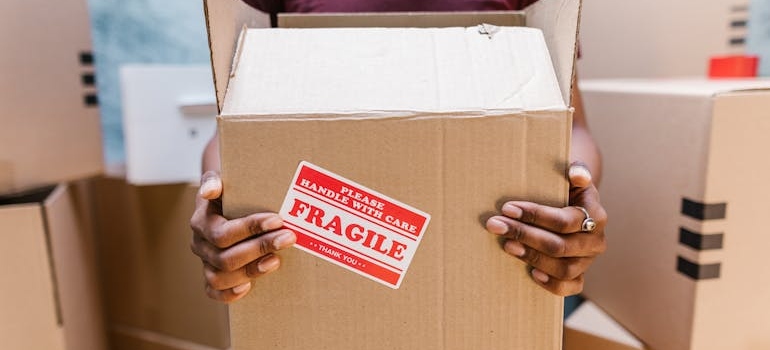 A man holding a box labeled fragile