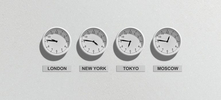 Four different clocks on the wall.