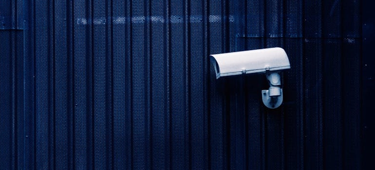 Choose between different types of storage with white security camera on a blue metal wall.
