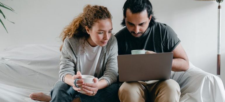 Couple reading a guide on packing wooden items for storage