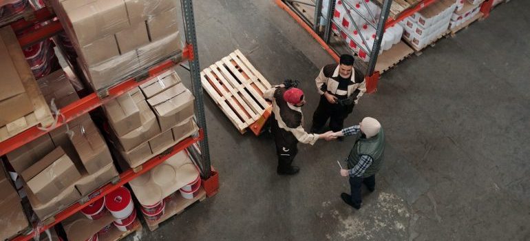 storage facility empolyees shaking hands, representing short term storage seattle services