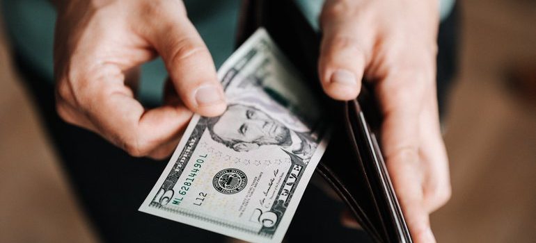 Person looking at their wallet.