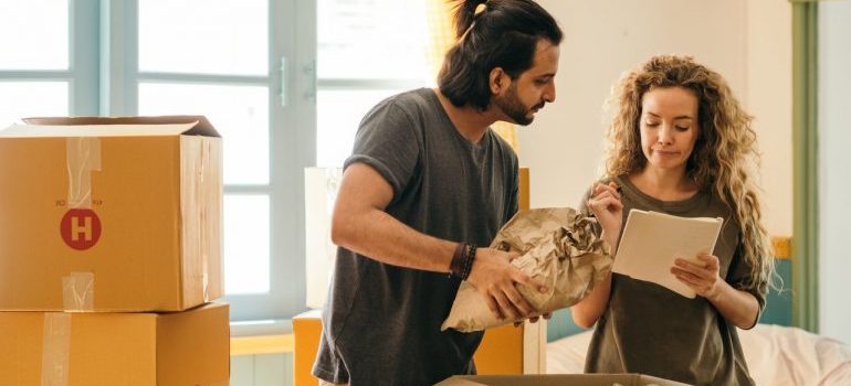 Couple preparing to store items after learning about the reasons to use storage during home renovation