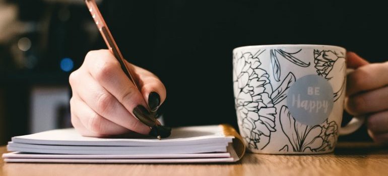 Woman making a list for storing summer season equipment