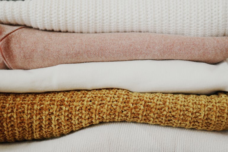 Pile of Folded Textiles ready for storing linen clothing and bedding