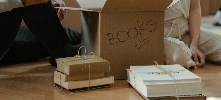Coupla packing books for storage