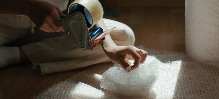 Person using the best packing material for fragile items
