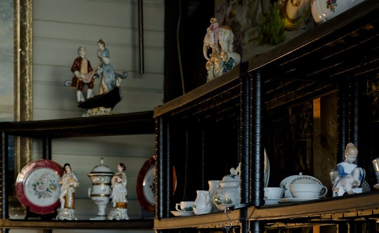 Ceramic tableware on shelves