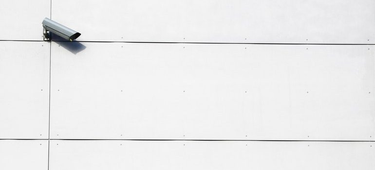 Security camera on a white wall.