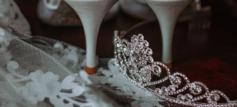 Bridal accessories and shoes placed on couch