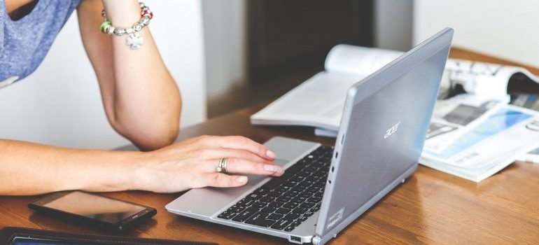 A woman researching improvised storage vs. professional storage on a laptop.