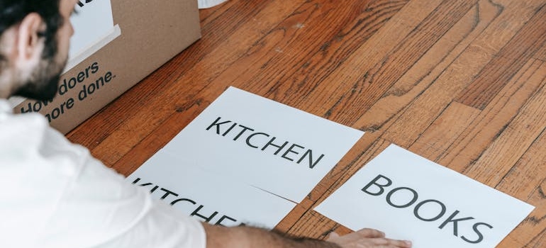 Man looking at printed materials on floor showing how to create an inventory for your storage