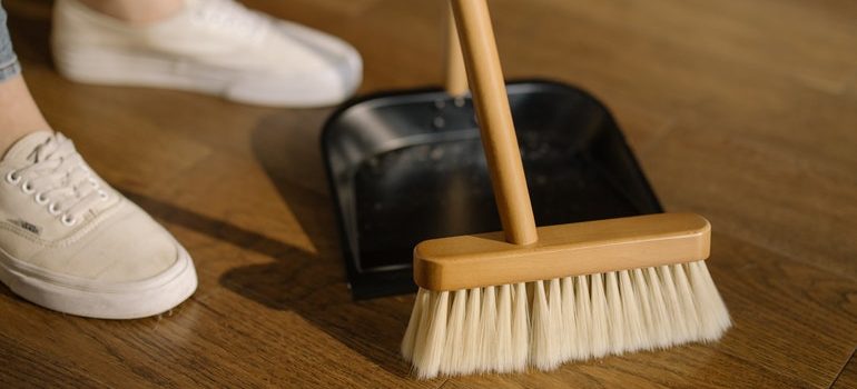 Person sweeping the floor.