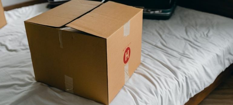 A cardboard box on a bed