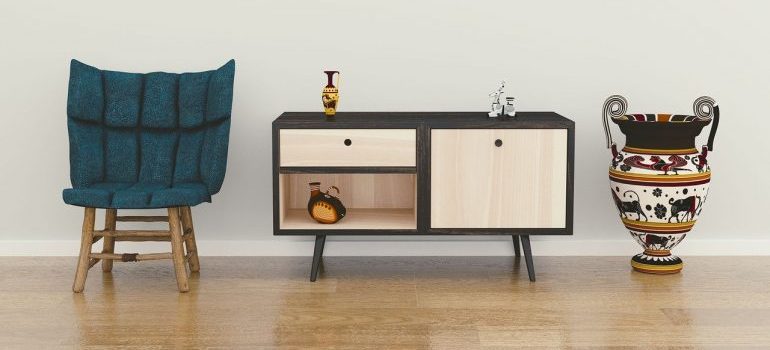 A chair, and end table, a vase.