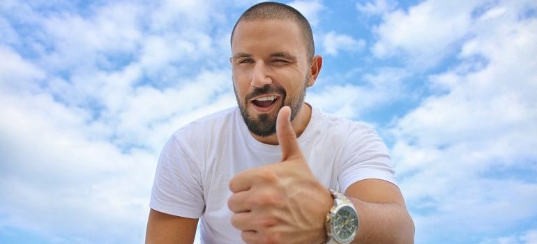A man showing a thumbs up gesture.