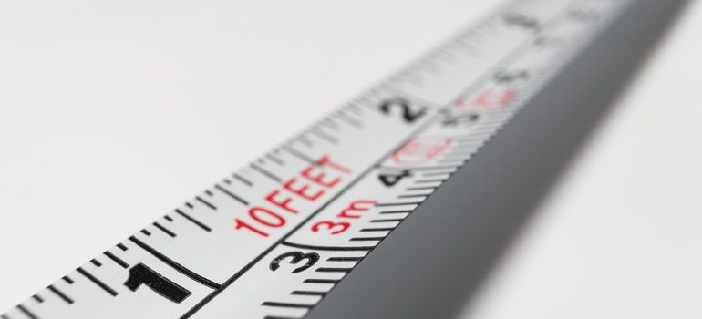 Measuring tape used to measure cardboard boxes vs plastic bins.