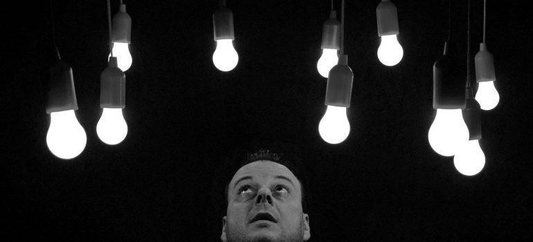 A man looking at light bulbs. 