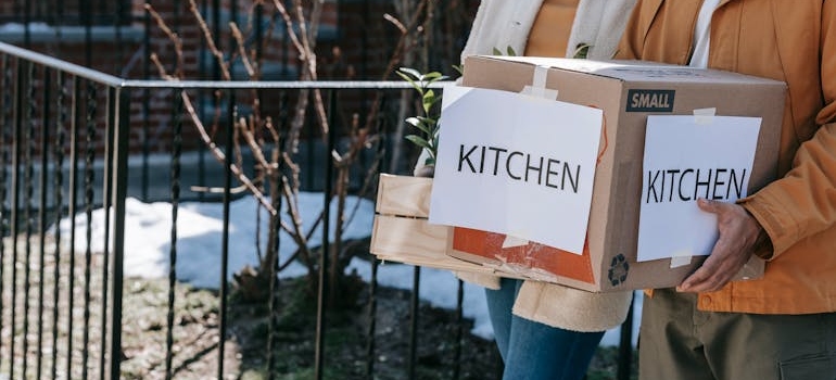 Man Carrying Packed Kitchen Wares In Box