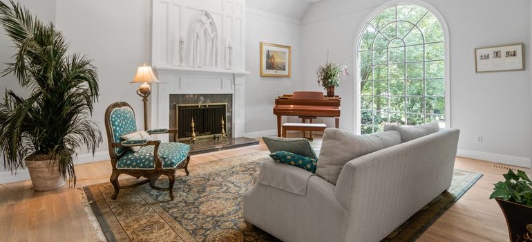 Stage living room with a piano and fireplace.