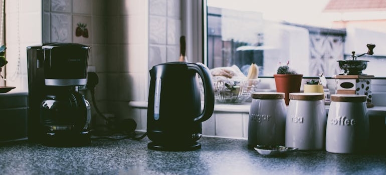 Two black kitchen appliances on a counter