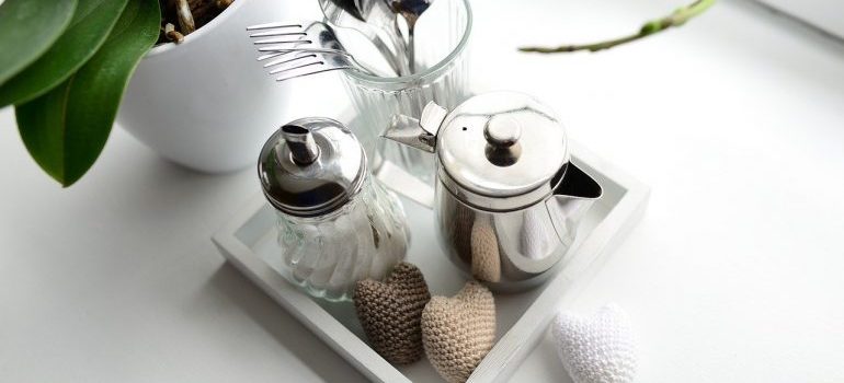 A tray with items in it, next to a plant.