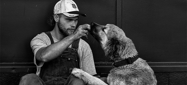 a man feeding a dog