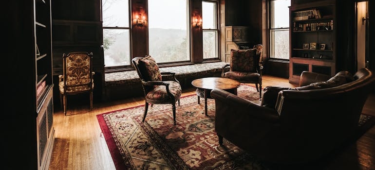 Armchairs, a sofa and a rug in a vintage living room