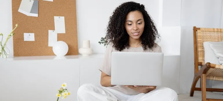 A woman researching the downsides of drive-up storage on her laptop