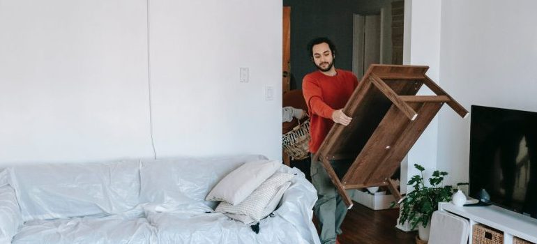 man carrying a table