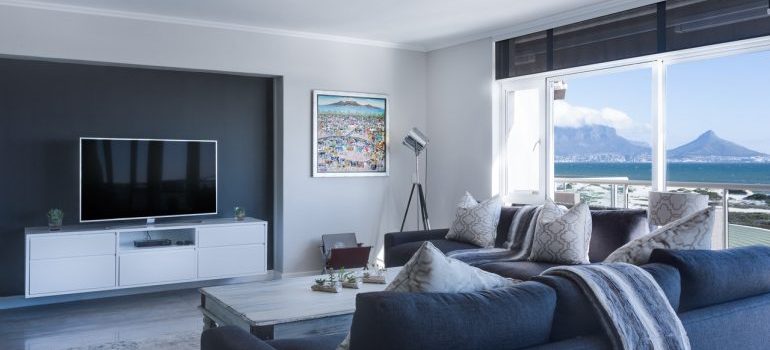 A light grey living room with mountain view.