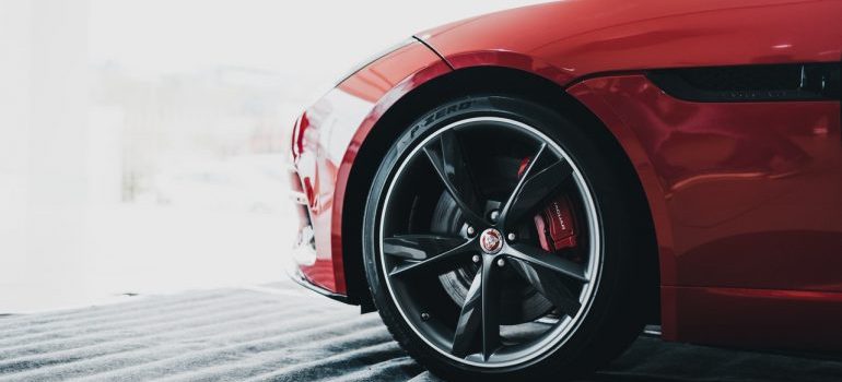 A clean tire on a red sports car