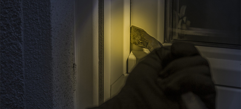 burglar opening a home