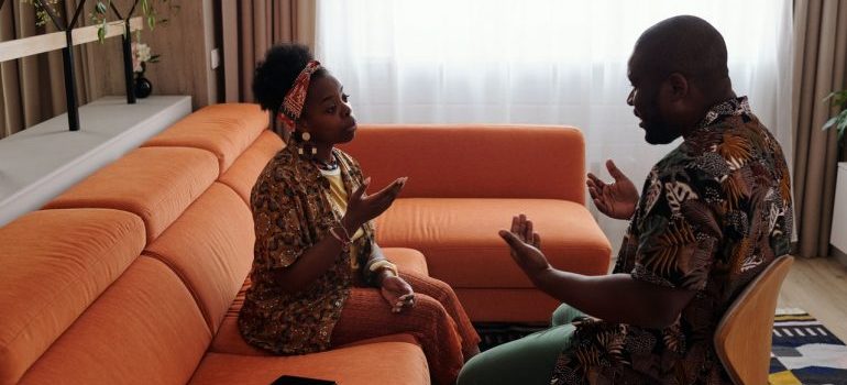 A couple arguing in the living room.