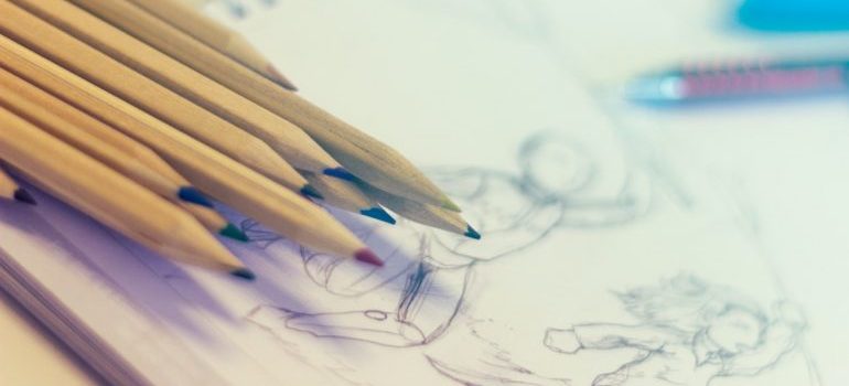Several pencils resting on a sketch