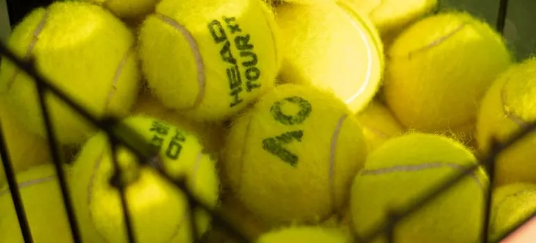 Basket full of yellow tennis balls is why sporting goods stores need self storage