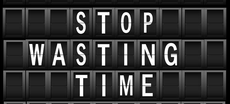 a sign that says stop wasting time 