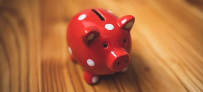 A red piggy bank with white spots.