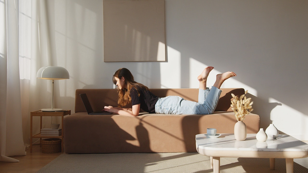 A woman relaxing after managing to relieve stress with self storage.