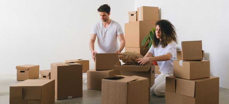 Couple packing their items after learning how self storage helps your home rental endeavors