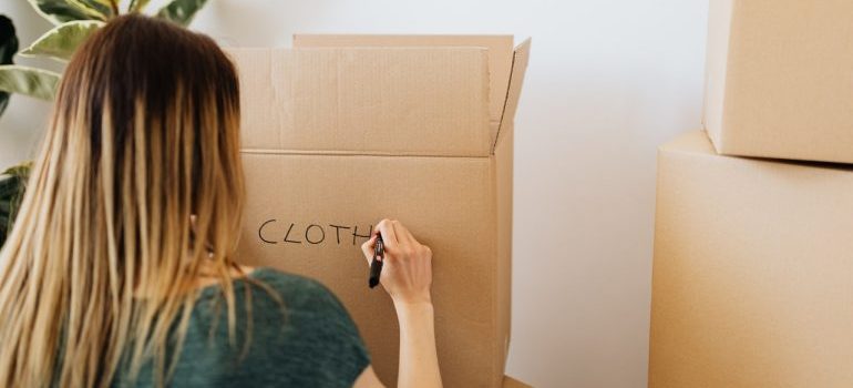 Woman labeling a box