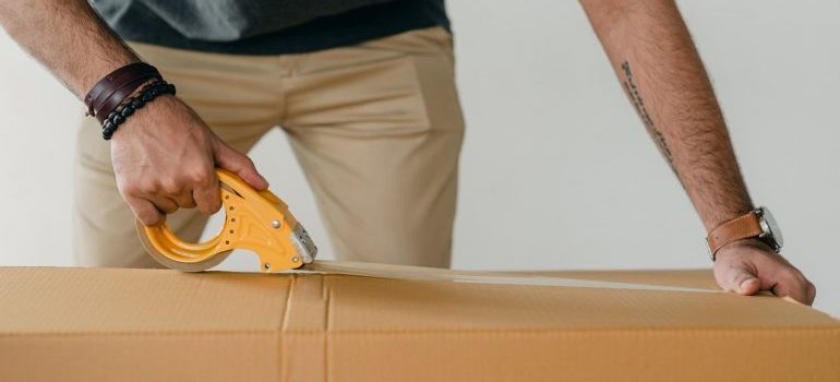 Person packing a box