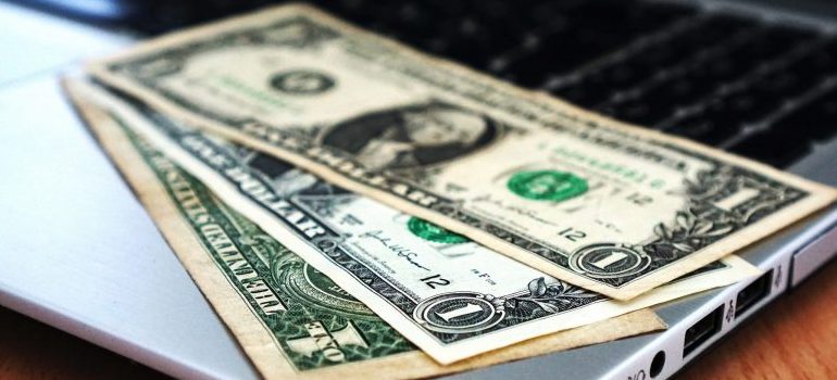 stack of $ bills, representing why you may want to be relocating your business with portable storage